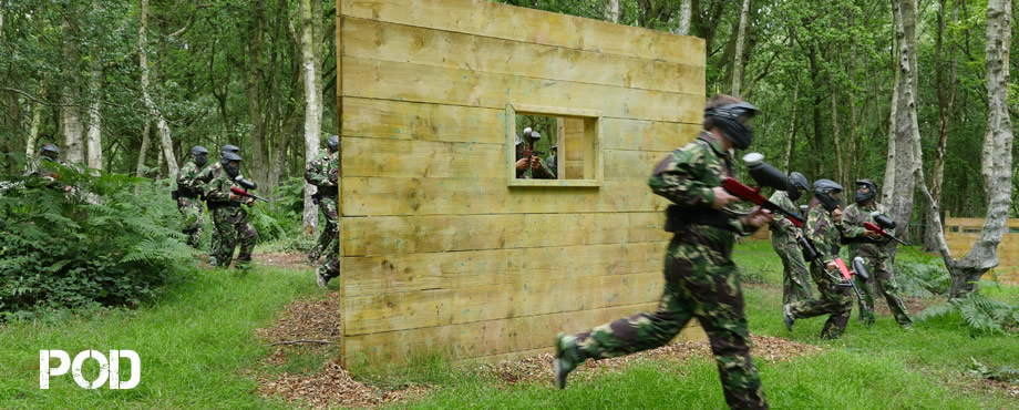 <A large image of three paintball players at Camoulfage Paintball>
